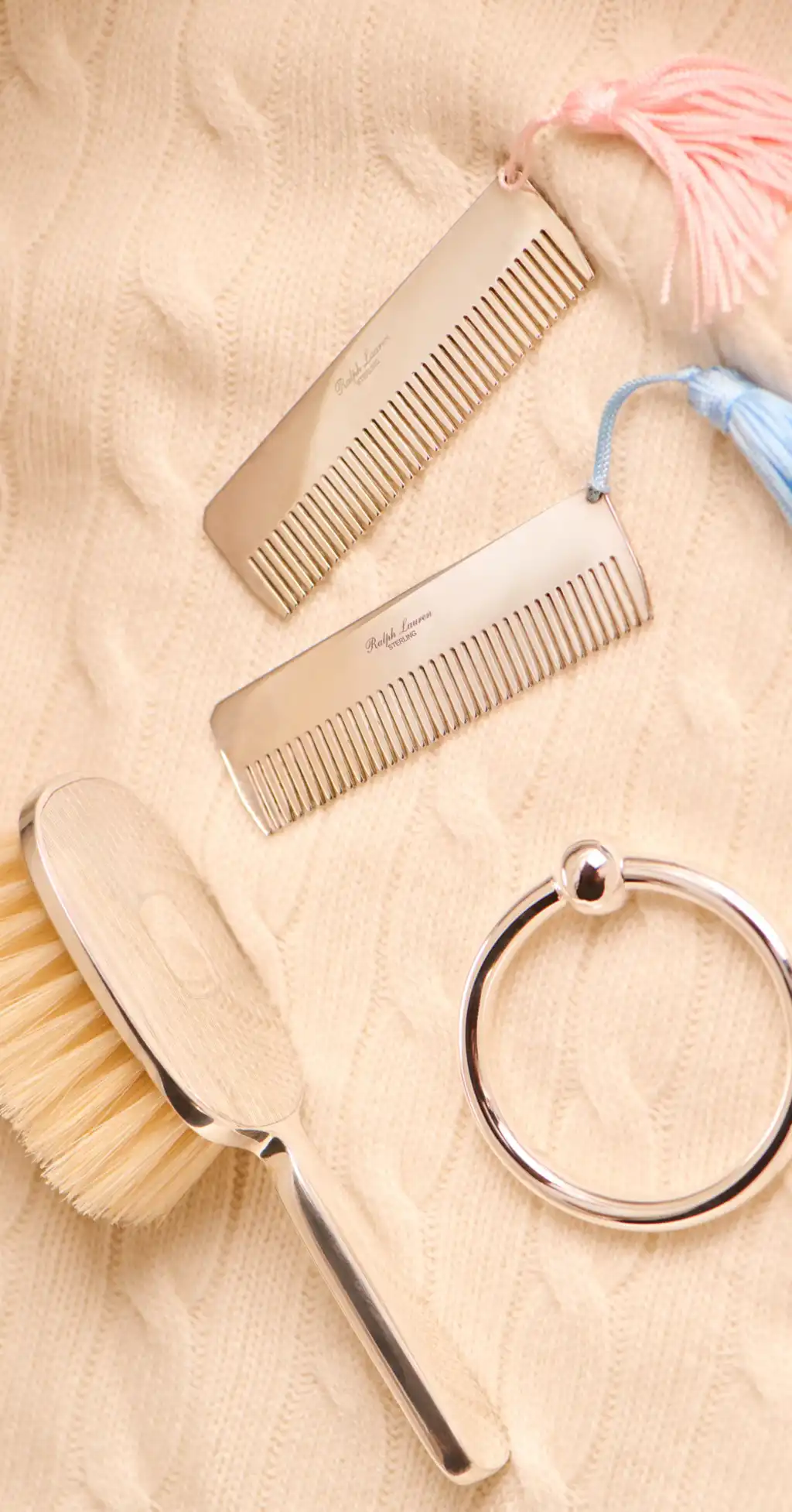 Ralph Lauren chrome combs and a brush set on a knitted blanket